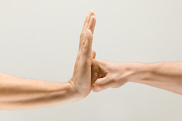 Image showing  loseup shot of male hands isolated on grey studio background.