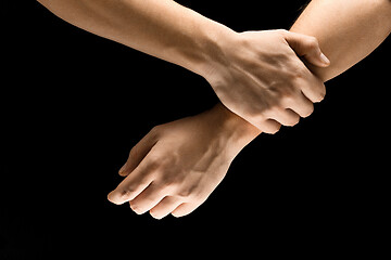 Image showing Male hands demonstrating a gesture of getting touch isolated on gray background