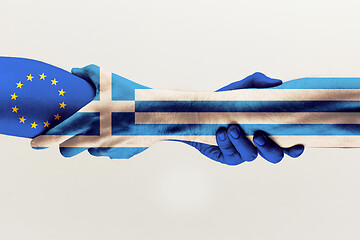 Image showing Male hands holding colored in blue EU and Greece flag