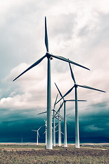 Image showing Wind turbines generating electricity in a stormy weather