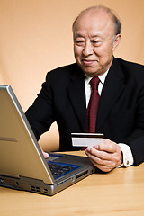 Image showing Senior asian businessman shopping online