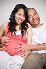 Image showing Happy expecting pregnant asian couple