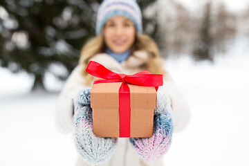 Image showing close up of woman with christmas gift in winter