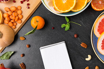 Image showing close up of notebook, fruits and vegetables