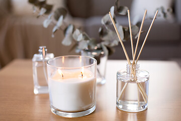 Image showing aroma reed diffuser, burning candle and perfume