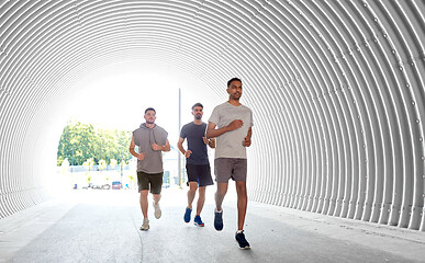 Image showing young men or male friends running outdoors