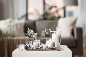 Image showing burning fragrance candles on table at cozy home