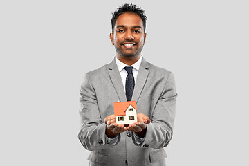 Image showing man realtor with house model and folder