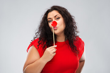 Image showing happy woman with red clown nose posing