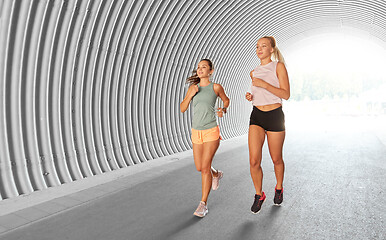 Image showing young women or female friends running outdoors