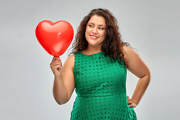 Image showing happy woman holding red heart shaped balloon