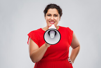 Image showing happy woman in red dress speaking to megaphone