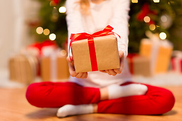 Image showing close up of girl with christmas gift at home