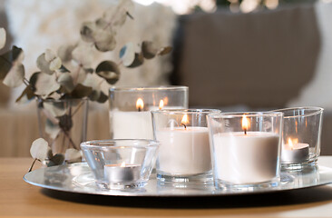Image showing burning fragrance candles on table at cozy home