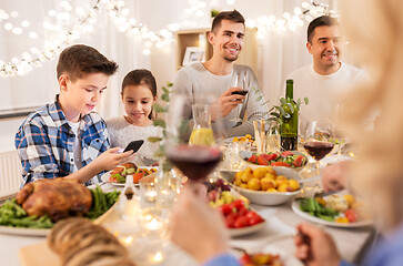 Image showing children with smartphone at family dinner party