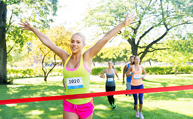 Image showing happy young female runner on finish winning race