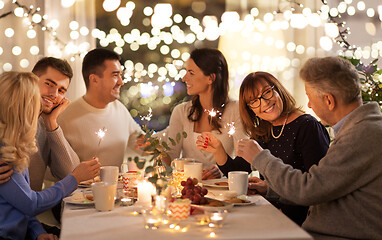 Image showing family with sparklers having dinner party at home