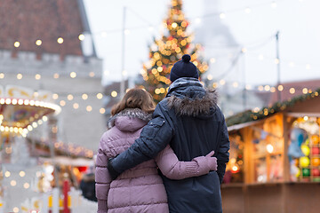 Image showing happy senior couple hugging at christmas market