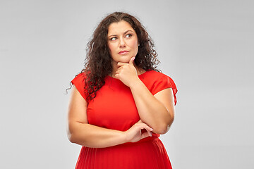 Image showing serious woman in red dress thinking