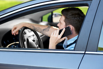 Image showing man driving car and calling on smartphone