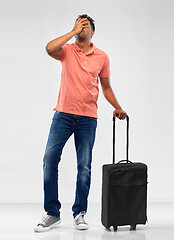 Image showing indian man with travel bag making face palm