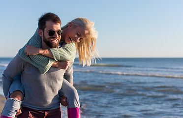 Image showing couple having fun at beach during autumn