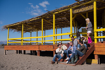 Image showing Group of friends having fun on autumn day at beach