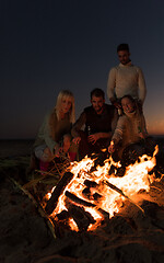 Image showing Friends having fun at beach on autumn day