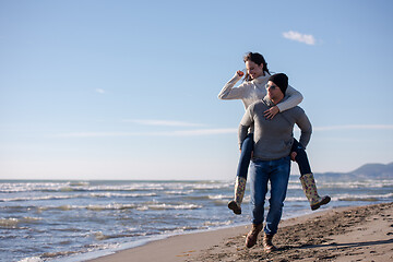 Image showing couple having fun at beach during autumn