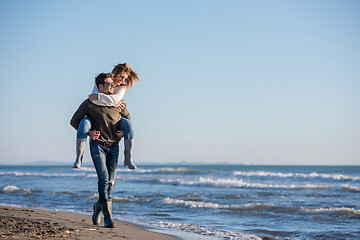 Image showing couple having fun at beach during autumn