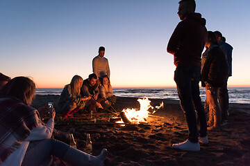 Image showing Friends having fun at beach on autumn day