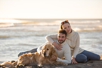 Image showing Couple with dog enjoying time on beach