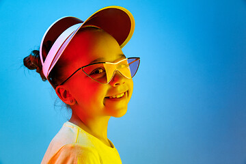 Image showing The happy teen girl standing and smiling against blue background.