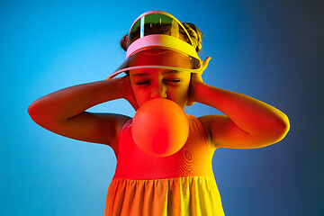 Image showing Young girl blowing bubble gum