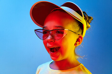 Image showing The happy teen girl standing and smiling against blue background.