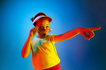 Image showing Beautiful teen girl looking suprised isolated on blue