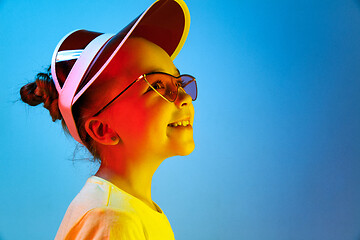 Image showing The happy teen girl standing and smiling against blue background.