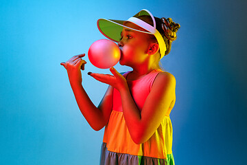 Image showing Young girl blowing bubble gum