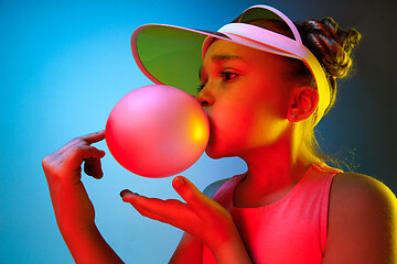 Image showing Young girl blowing bubble gum