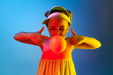 Image showing Young girl blowing bubble gum