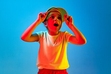 Image showing Beautiful teen girl looking suprised isolated on blue