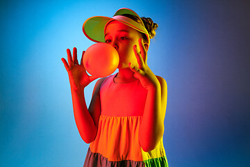 Image showing Young girl blowing bubble gum