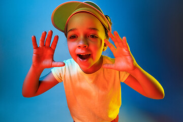 Image showing Beautiful teen girl looking suprised isolated on blue