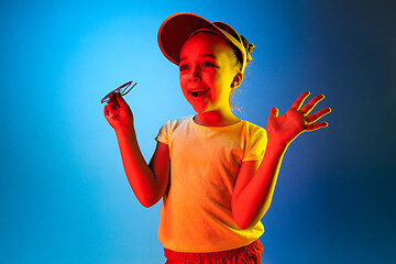 Image showing Beautiful teen girl looking suprised isolated on blue