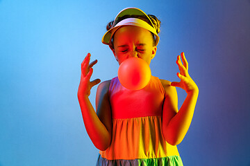 Image showing Young girl blowing bubble gum