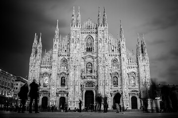 Image showing Milan Cathedral , Duomo di Milano, is the gothic cathedral church of Milan, Italy. Shot in the dusk from the square ful of people.