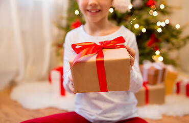 Image showing close up of girl with christmas gift at home