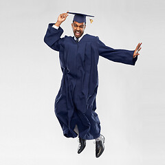 Image showing happy male indian graduate student jumping