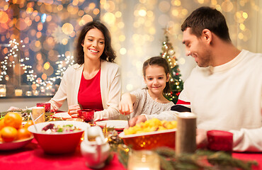 Image showing happy family having christmas dinner at home