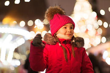 Image showing happy girl with sparkler at christmas market